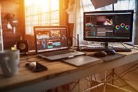 Freelance desktop with laptop computer and monitor review for editor work with content video or equipment video of vlog